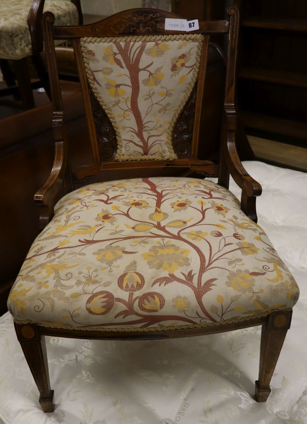 A late Victorian marquetry inlaid rosewood low seat chair